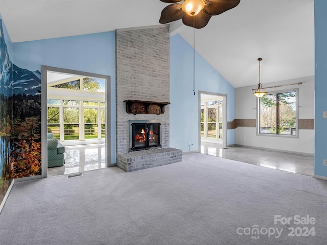 unfurnished living room featuring light carpet, high vaulted ceiling, and a fireplace