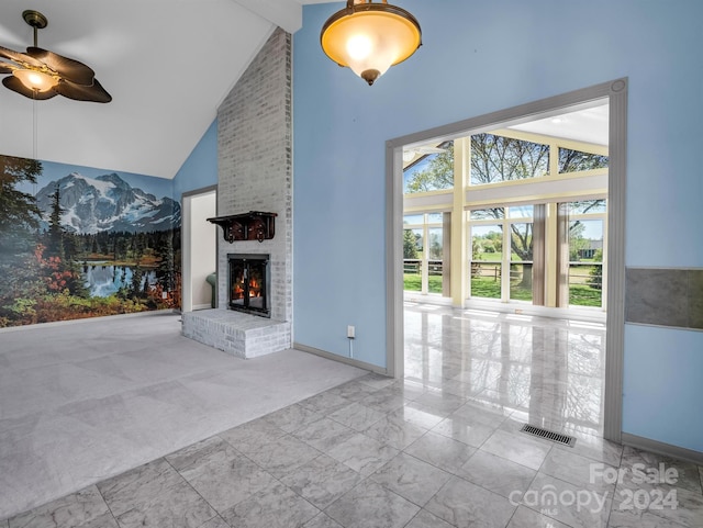 unfurnished living room with light colored carpet, a brick fireplace, ceiling fan, brick wall, and beamed ceiling