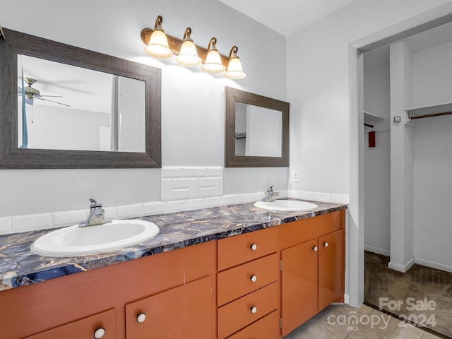 bathroom featuring ceiling fan, tile floors, and dual bowl vanity