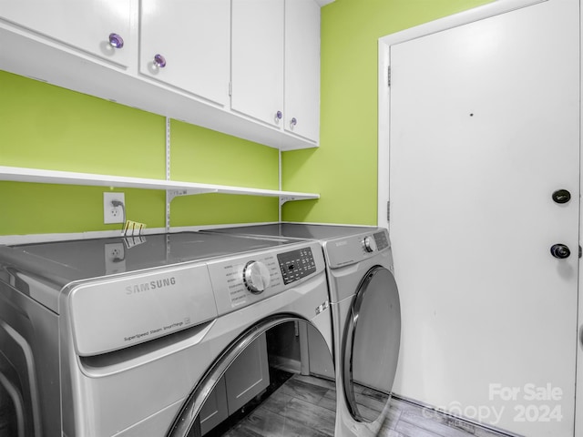 laundry area with tile flooring, cabinets, and washer and dryer