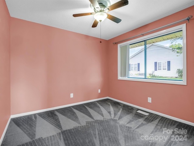 carpeted empty room featuring ceiling fan