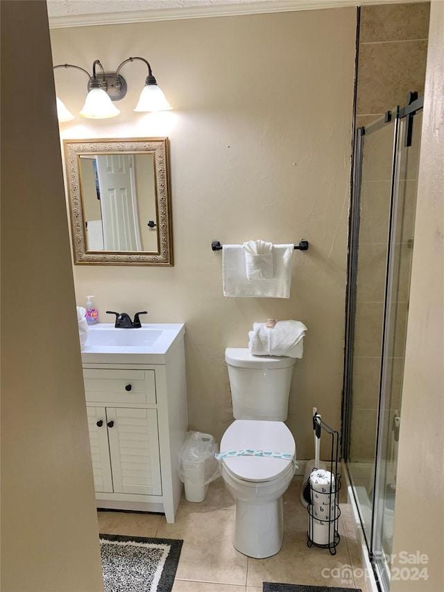 bathroom featuring walk in shower, crown molding, toilet, and vanity