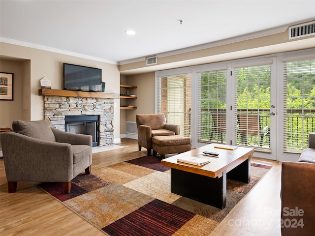 living room featuring a wealth of natural light, light hardwood / wood-style flooring, and a fireplace