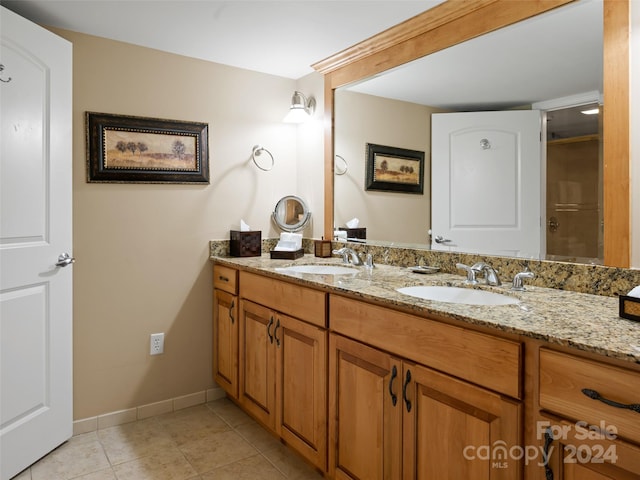 bathroom with tile flooring, dual sinks, and large vanity