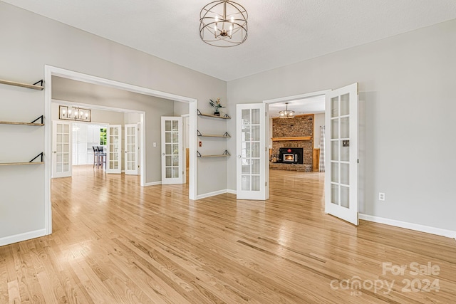 interior space featuring french doors, a chandelier, and hardwood / wood-style flooring