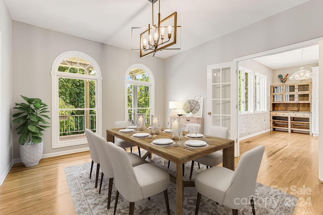 dining area featuring a notable chandelier and light wood-type flooring