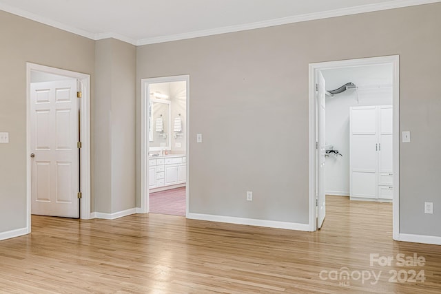 unfurnished room with light hardwood / wood-style flooring and ornamental molding