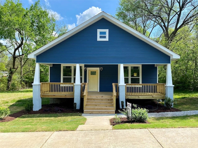 view of front of home with covered porch and a front lawn