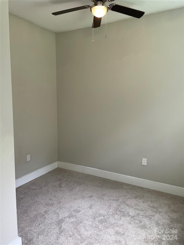 spare room featuring ceiling fan and carpet