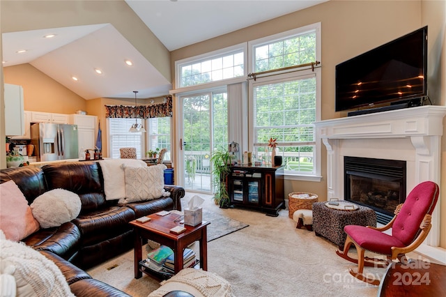 carpeted living room with high vaulted ceiling