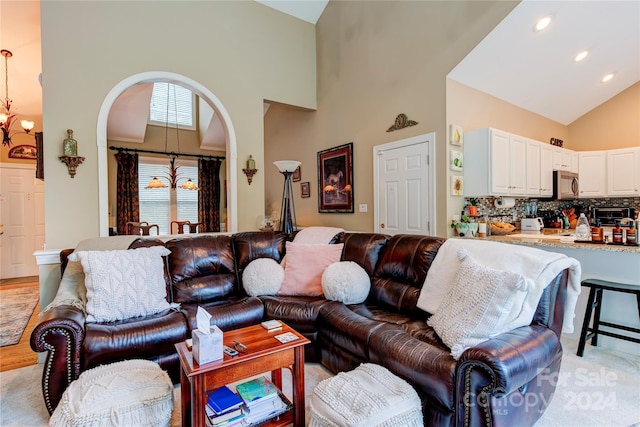 living room with high vaulted ceiling