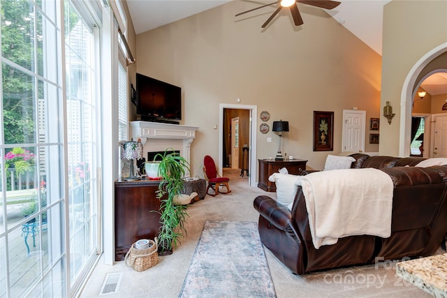 living room with carpet flooring, ceiling fan, and high vaulted ceiling