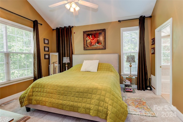 carpeted bedroom featuring ensuite bath, ceiling fan, and vaulted ceiling