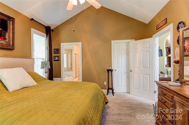 carpeted bedroom with ensuite bathroom, vaulted ceiling, and ceiling fan