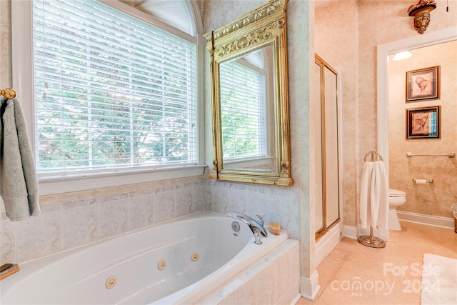 bathroom featuring tile patterned floors, toilet, plenty of natural light, and independent shower and bath