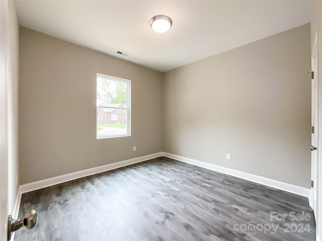 unfurnished room with dark hardwood / wood-style floors