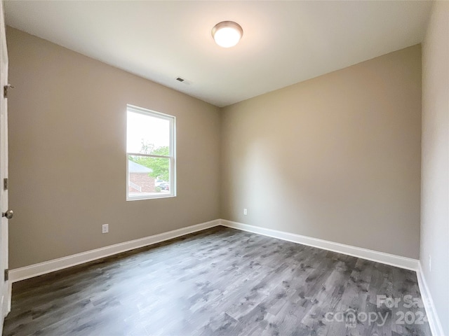 unfurnished room featuring dark hardwood / wood-style floors