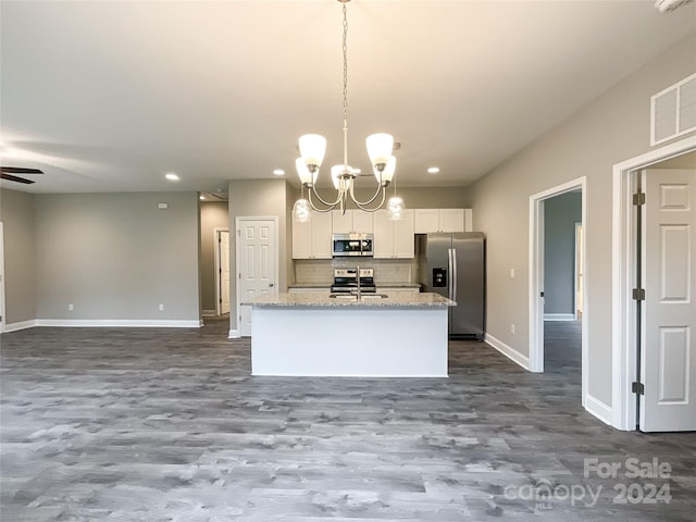 kitchen featuring white cabinets, ceiling fan with notable chandelier, hardwood / wood-style floors, stainless steel appliances, and pendant lighting