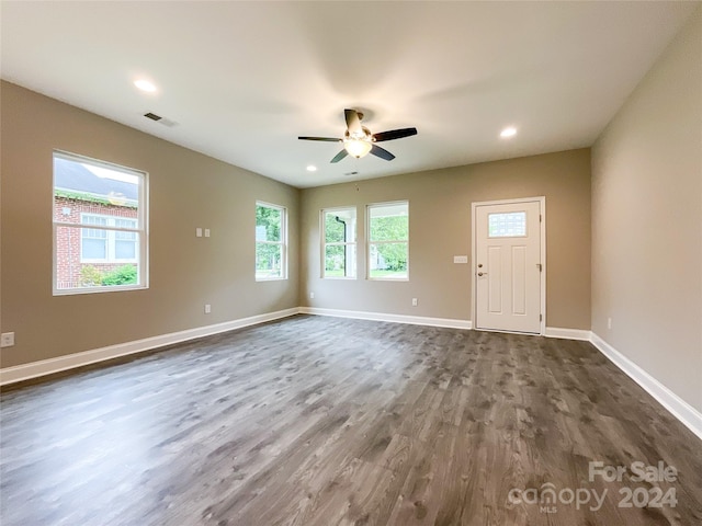 empty room featuring ceiling fan and dark hardwood / wood-style flooring