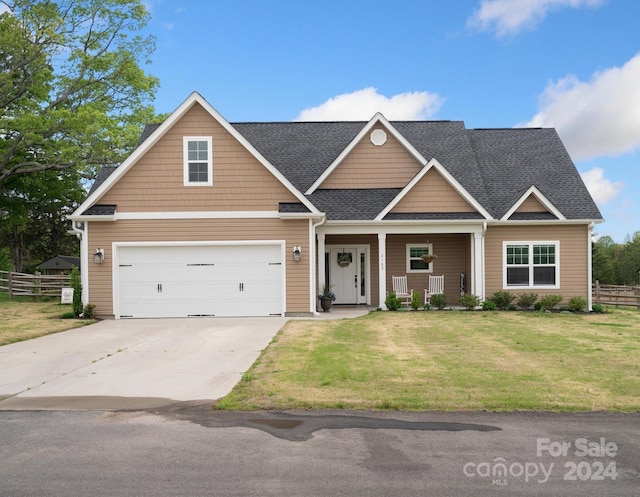 craftsman-style house featuring a front yard and a garage