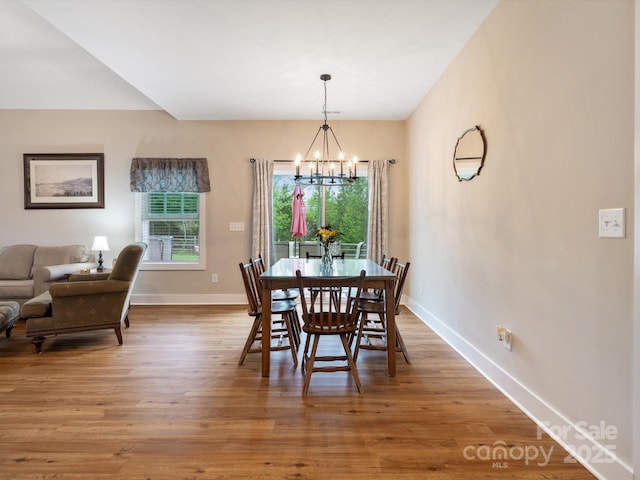 dining area featuring a notable chandelier and wood-type flooring