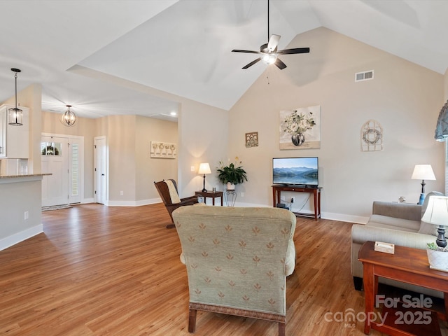 living room featuring ceiling fan, high vaulted ceiling, and light wood-type flooring