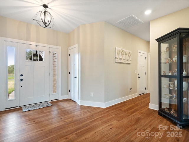 foyer featuring a notable chandelier and wood-type flooring