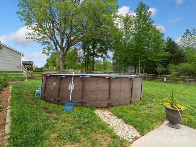 view of yard featuring a fenced in pool