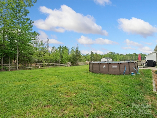 view of yard with a fenced in pool