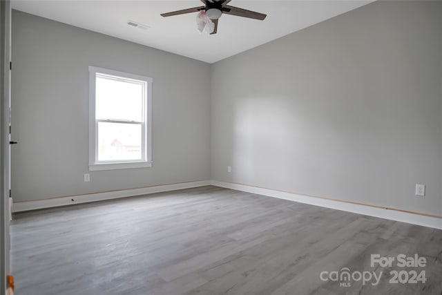 spare room with ceiling fan and light hardwood / wood-style flooring