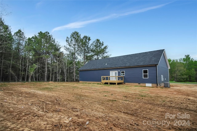 back of property with cooling unit and a wooden deck