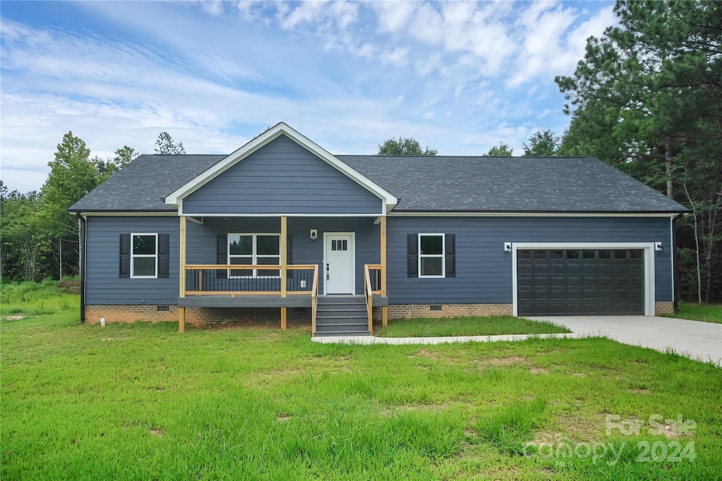 single story home featuring a garage, a front lawn, and covered porch