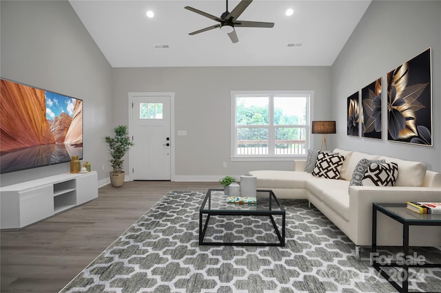 living room featuring hardwood / wood-style flooring, ceiling fan, and high vaulted ceiling