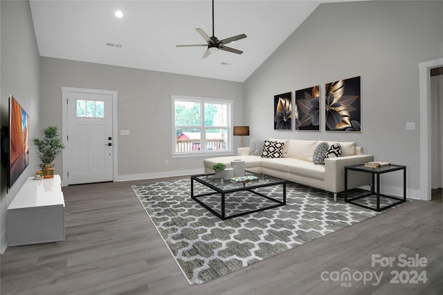 living room with wood-type flooring, high vaulted ceiling, and ceiling fan