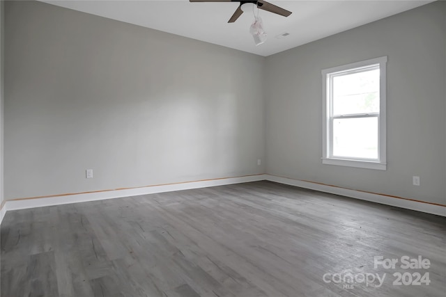 empty room with hardwood / wood-style floors and ceiling fan