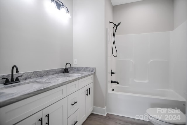 full bathroom featuring vanity, toilet,  shower combination, and hardwood / wood-style floors