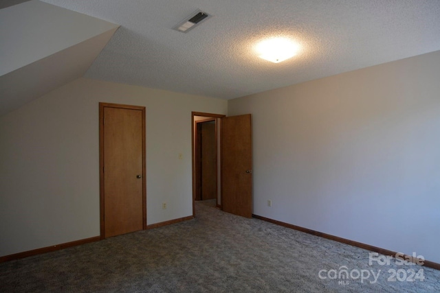 bonus room with light carpet, a textured ceiling, and lofted ceiling