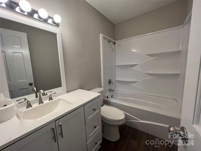 full bathroom featuring bathtub / shower combination, vanity, hardwood / wood-style flooring, and toilet