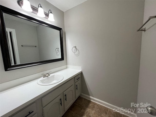 bathroom with tile floors and vanity with extensive cabinet space