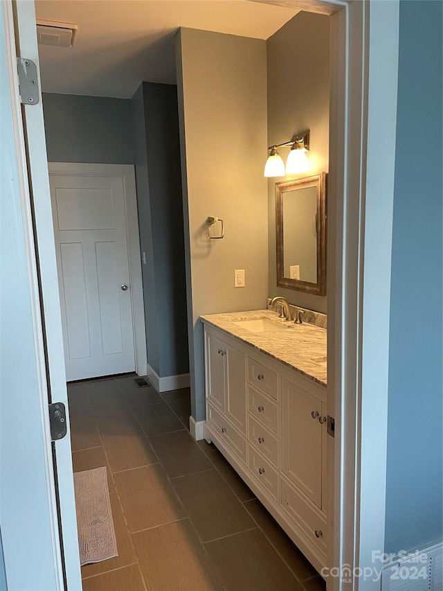 bathroom featuring tile flooring and vanity