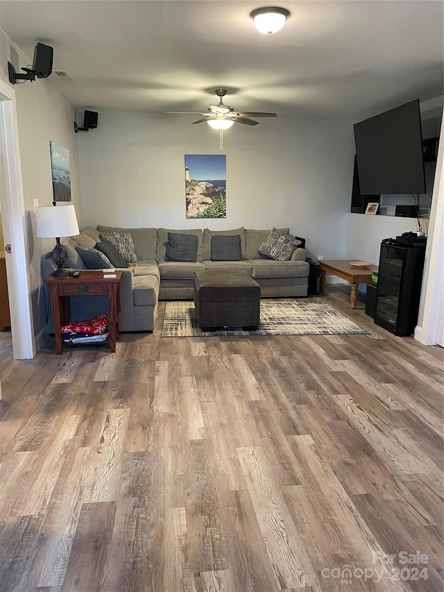 living room with hardwood / wood-style floors and ceiling fan