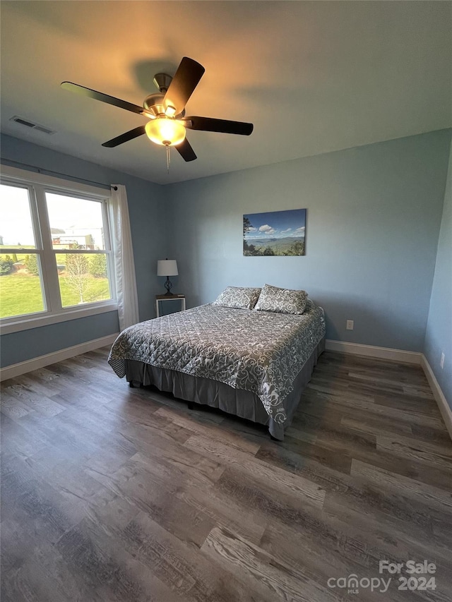 bedroom featuring dark hardwood / wood-style flooring and ceiling fan