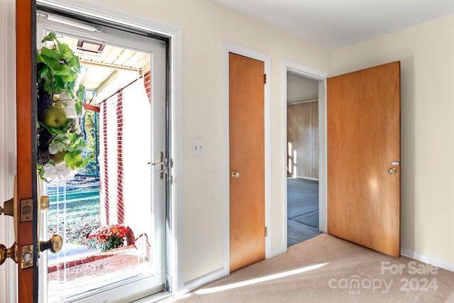 doorway to outside featuring carpet floors