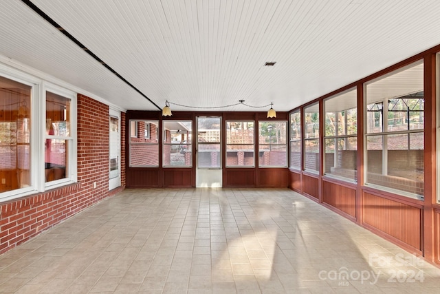 unfurnished sunroom featuring a healthy amount of sunlight