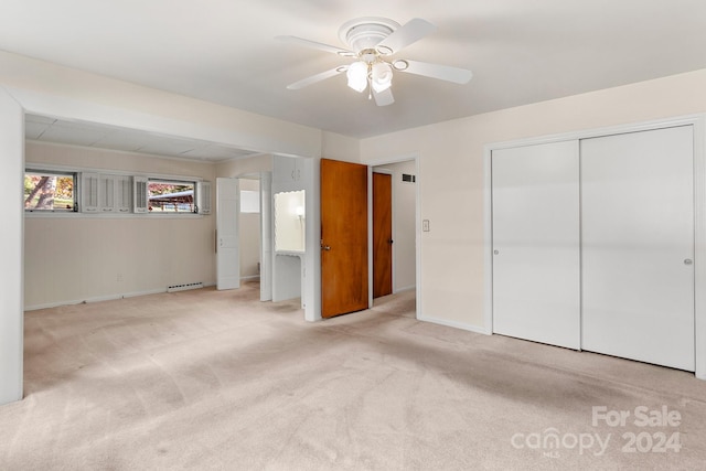 unfurnished bedroom with light carpet, a closet, and ceiling fan