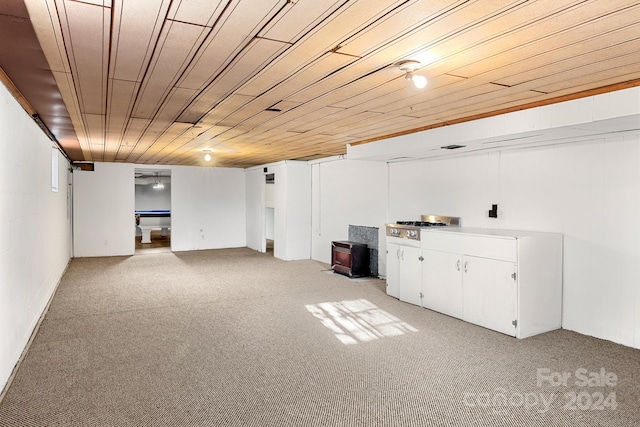 basement featuring light colored carpet and wooden ceiling