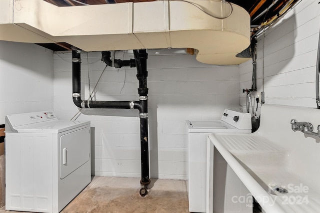 laundry room featuring washing machine and dryer and sink