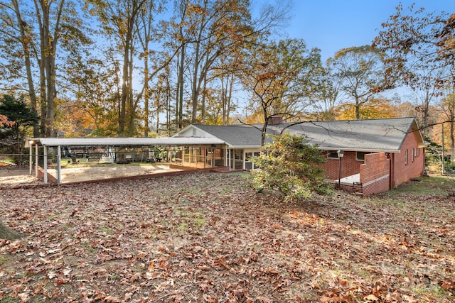 back of property featuring a carport