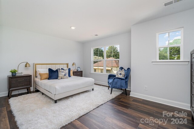 bedroom with dark hardwood / wood-style flooring