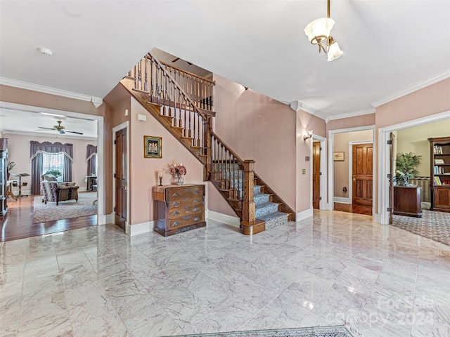 interior space with ceiling fan and ornamental molding